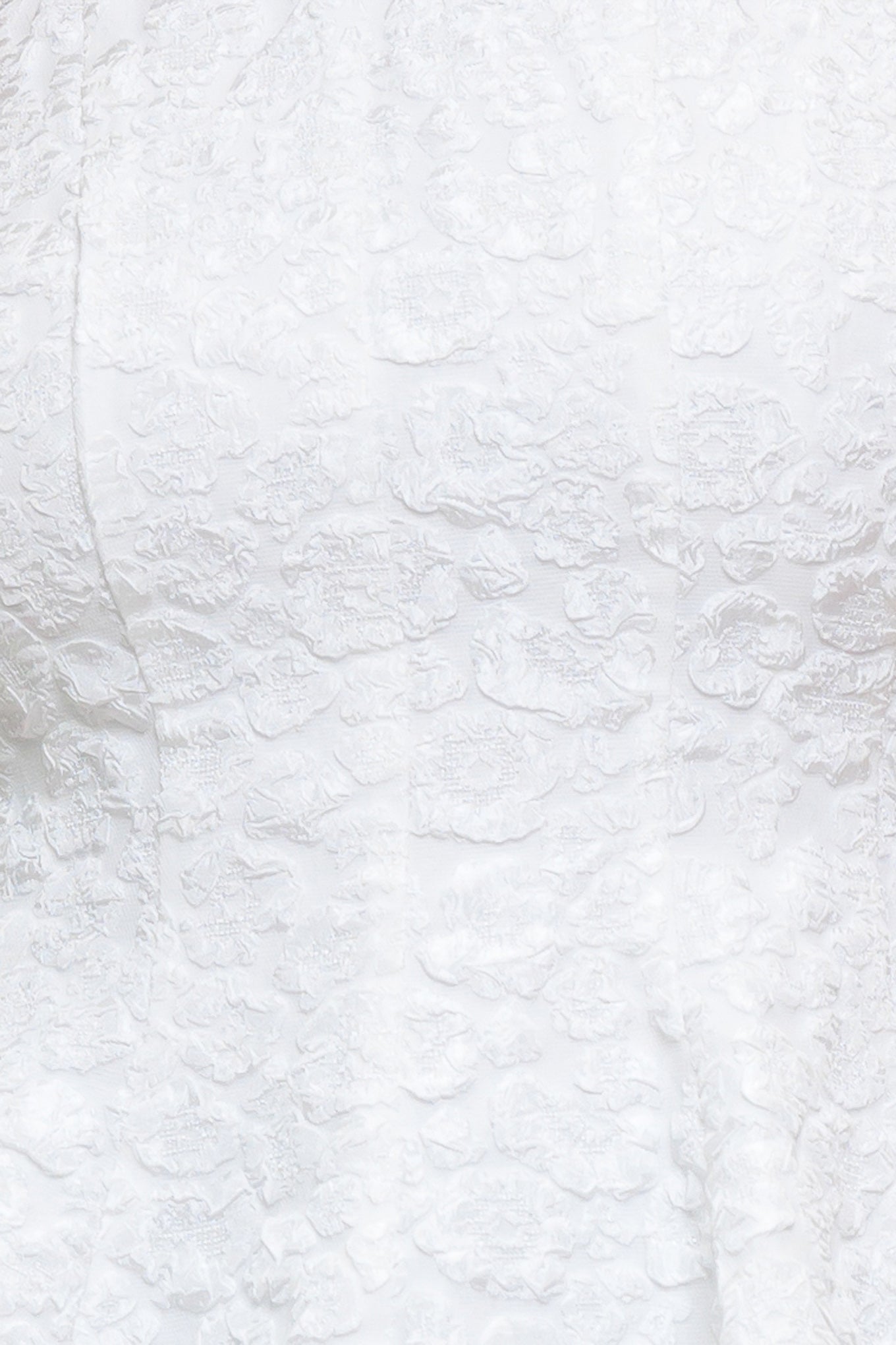 A texture woven top featuring round neckline, bow detail at shoulder, peplum and back zipper closure