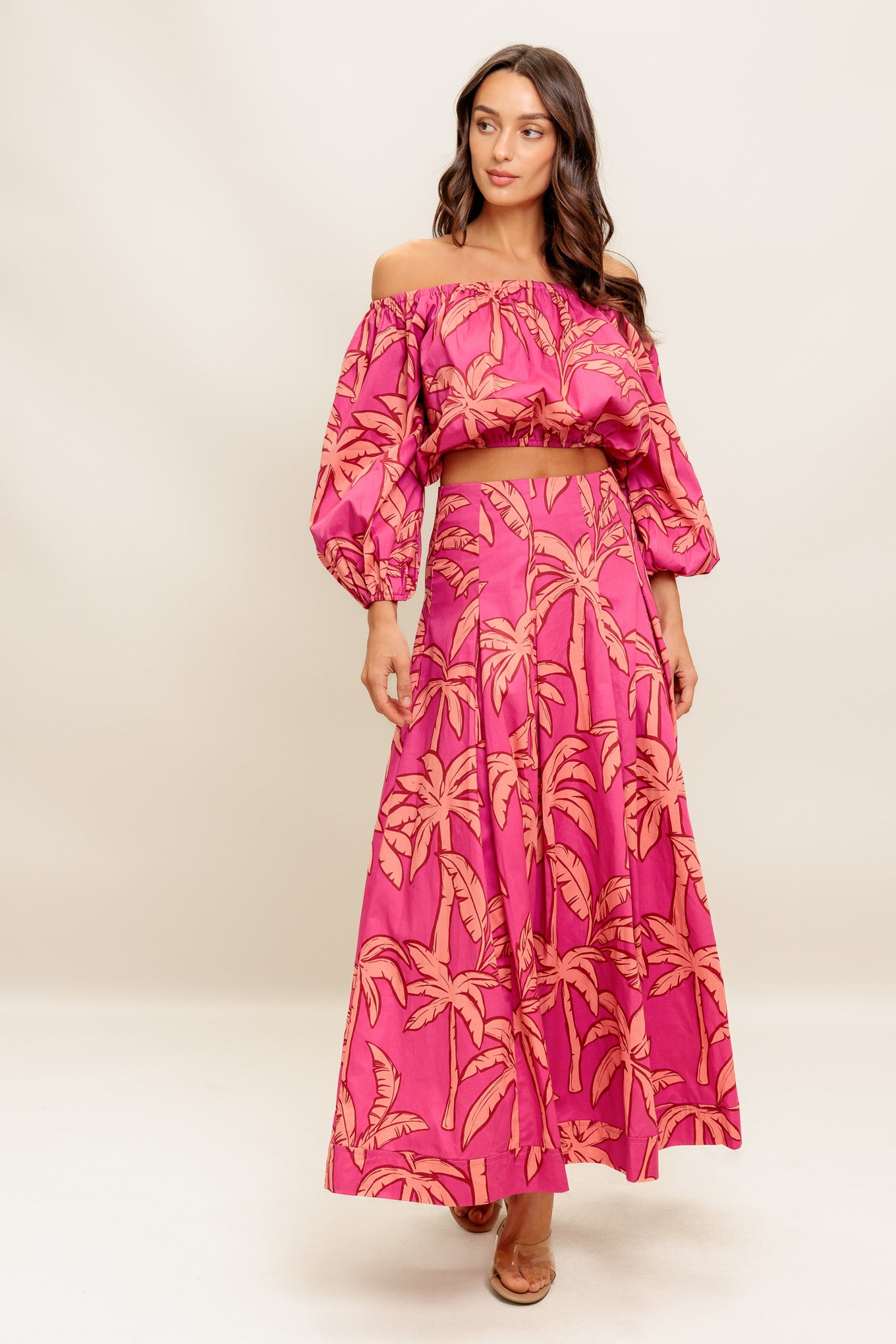 A printed woven top and skirt set. Top featuring off shoulder neckline, 3/4 sleeve and elasticized waist. Circle midi skirt with back zipper closure