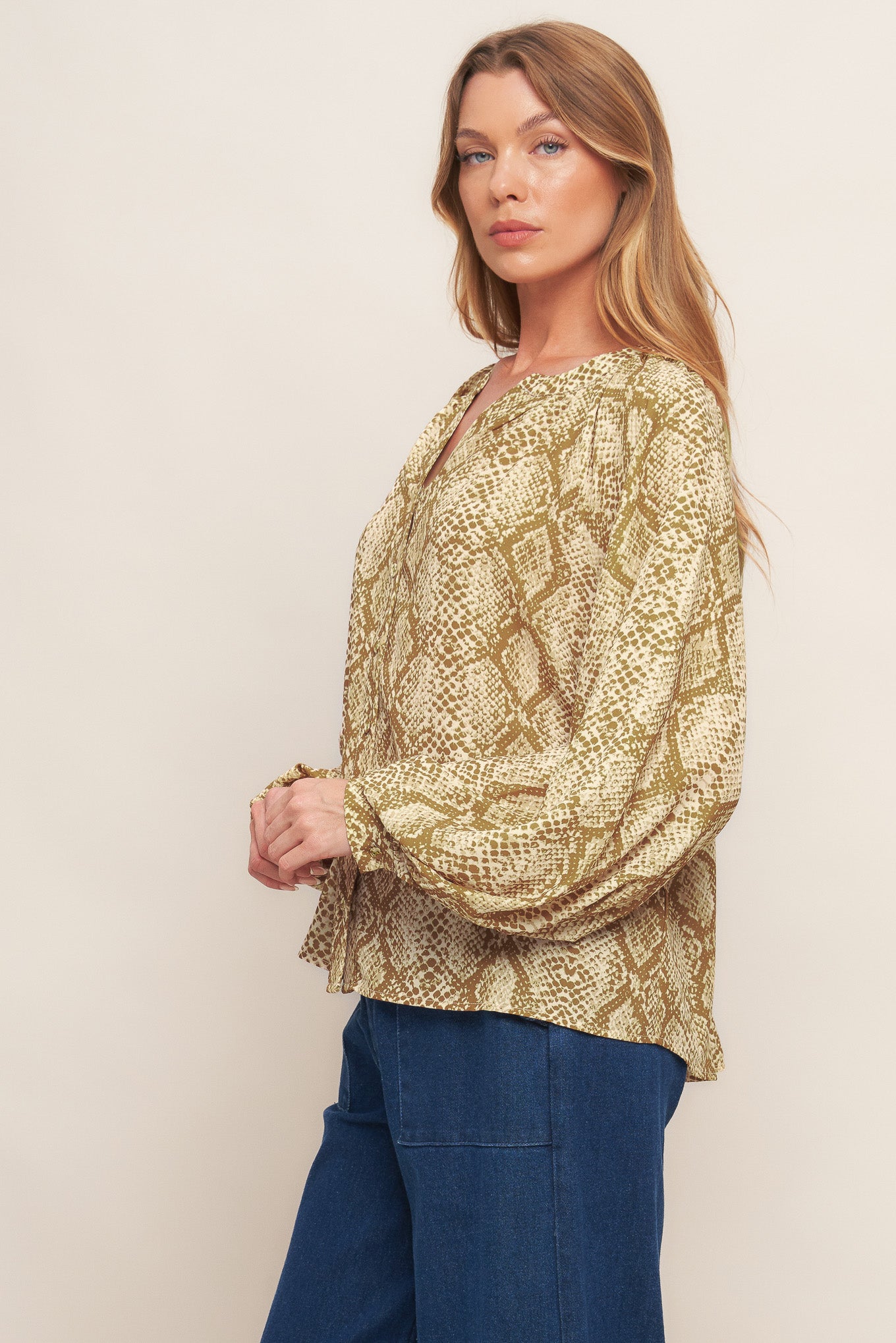 A printed woven top with round neckline, long sleeve and front button down