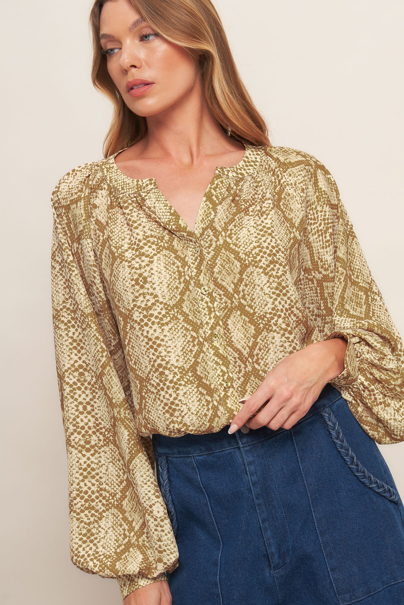 A printed woven top with round neckline, long sleeve and front button down