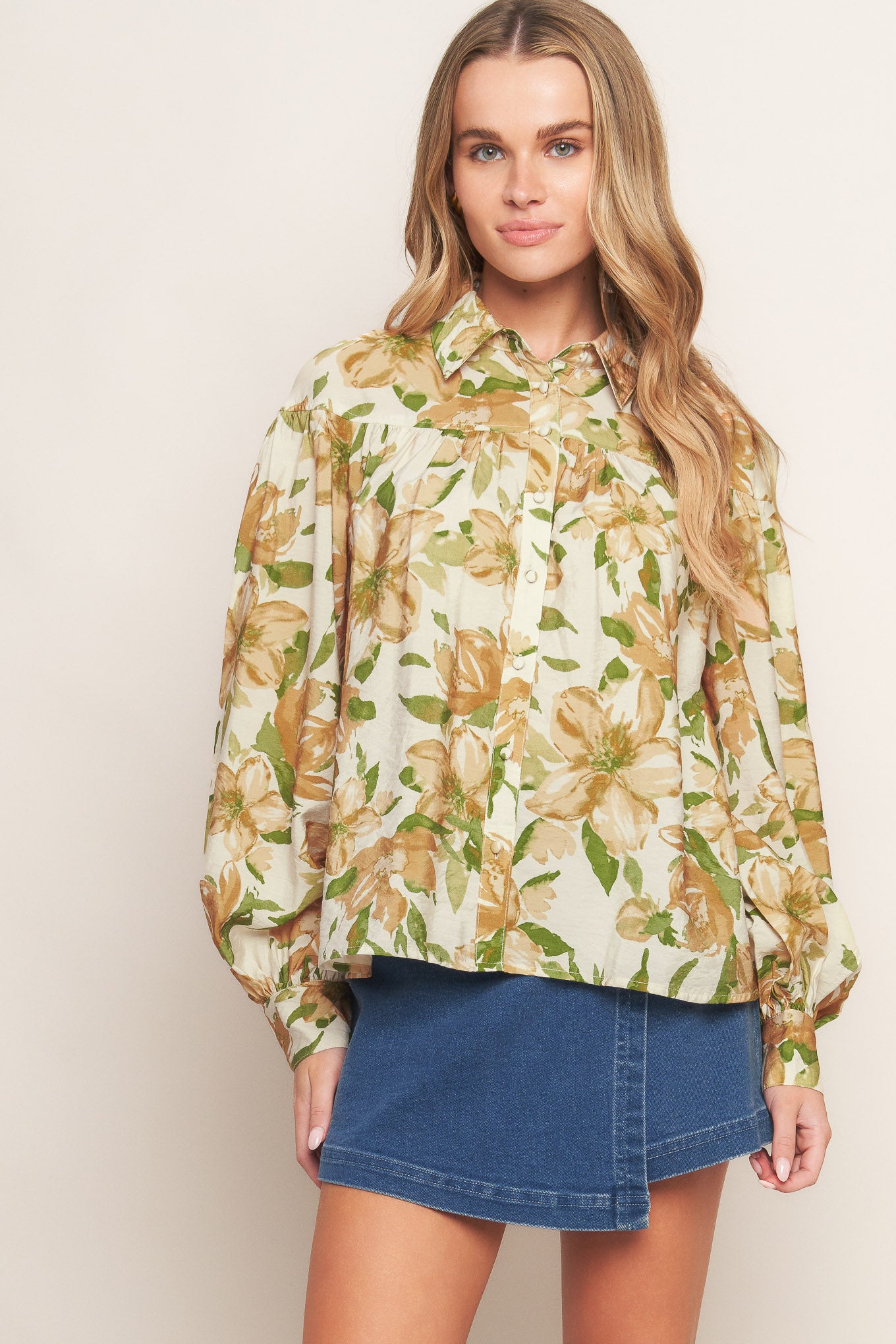 A printed woven top featuring collar, button down and long sleeve