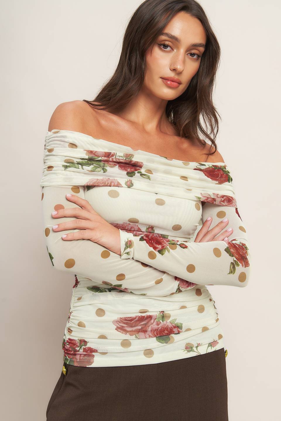 A printed power mesh top featuring off shoulder neckline with fold over, long sleeve and shirred body