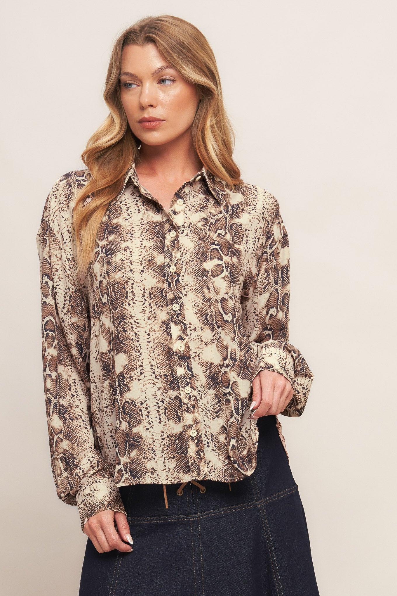 A printed woven top featuring collar, front button down and long sleeve with cuff