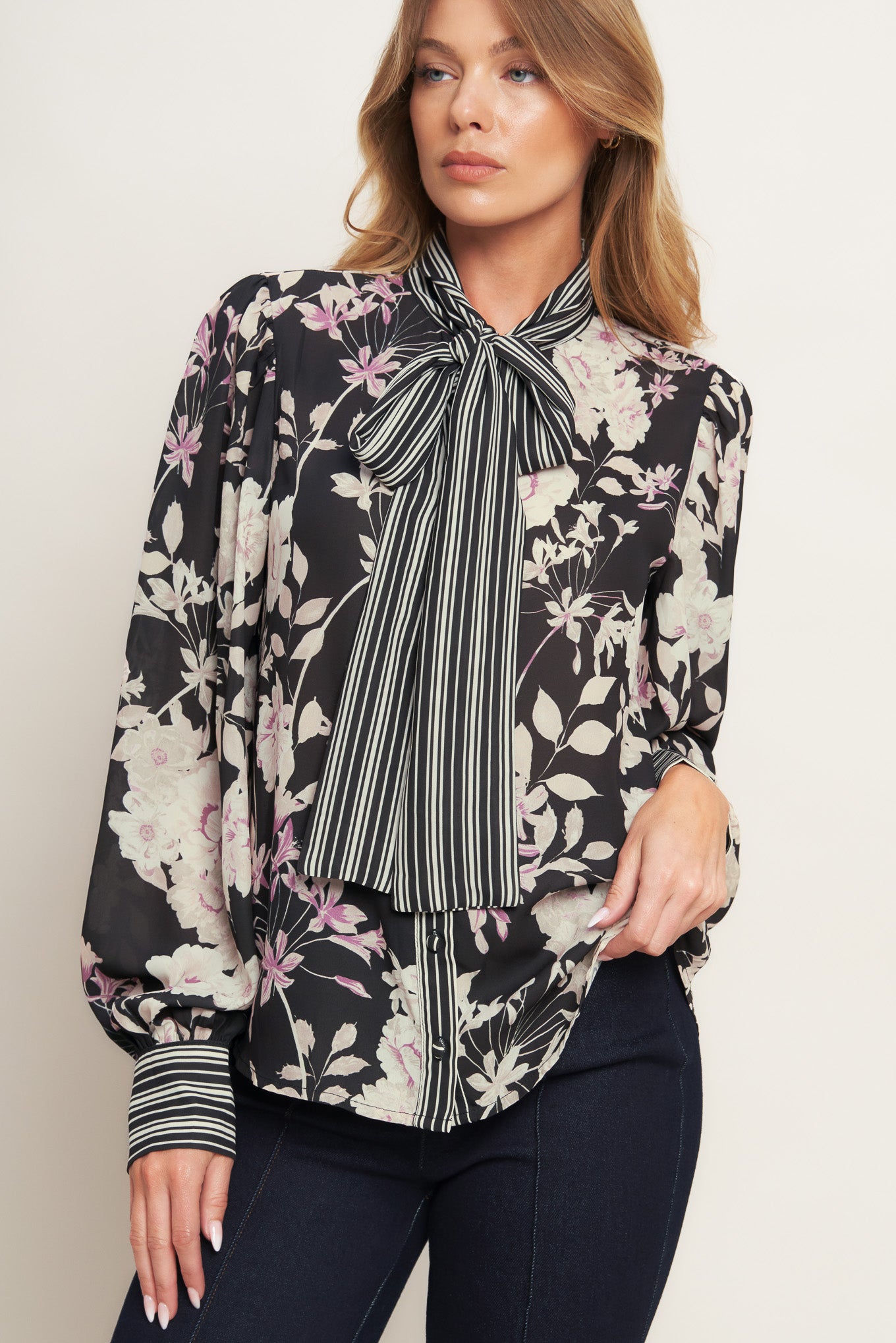 A printed woven top with front bow tie, long sleeve and button down