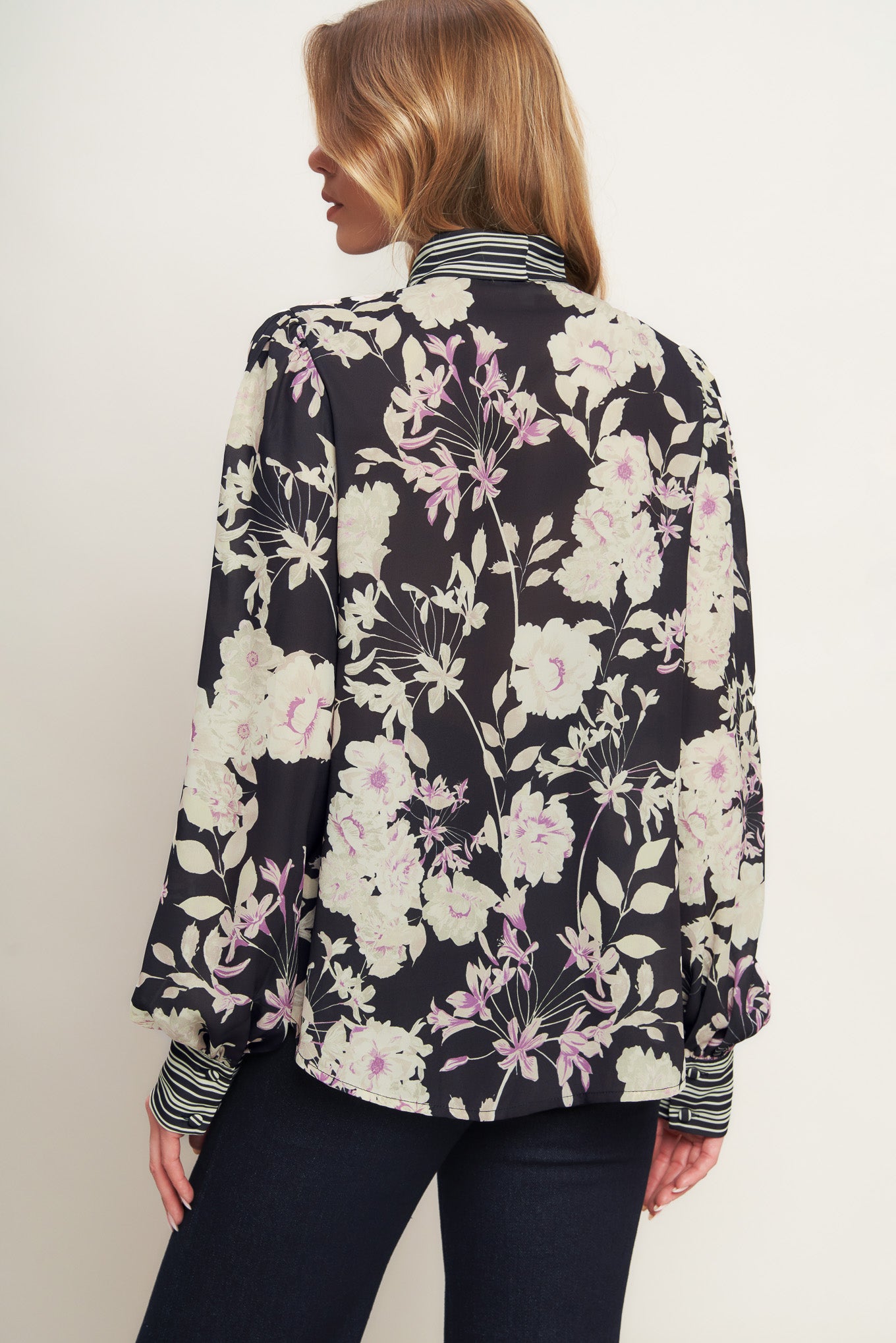 A printed woven top with front bow tie, long sleeve and button down