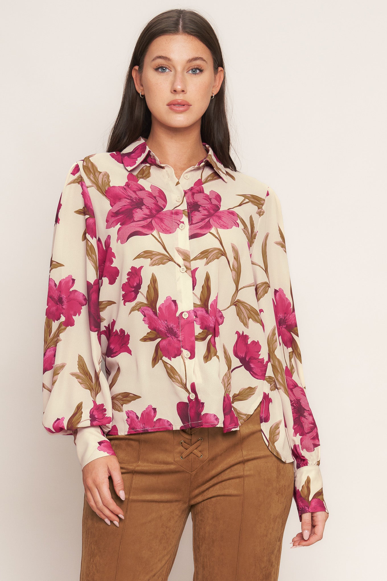 A printed woven top with front button down and long sleeve