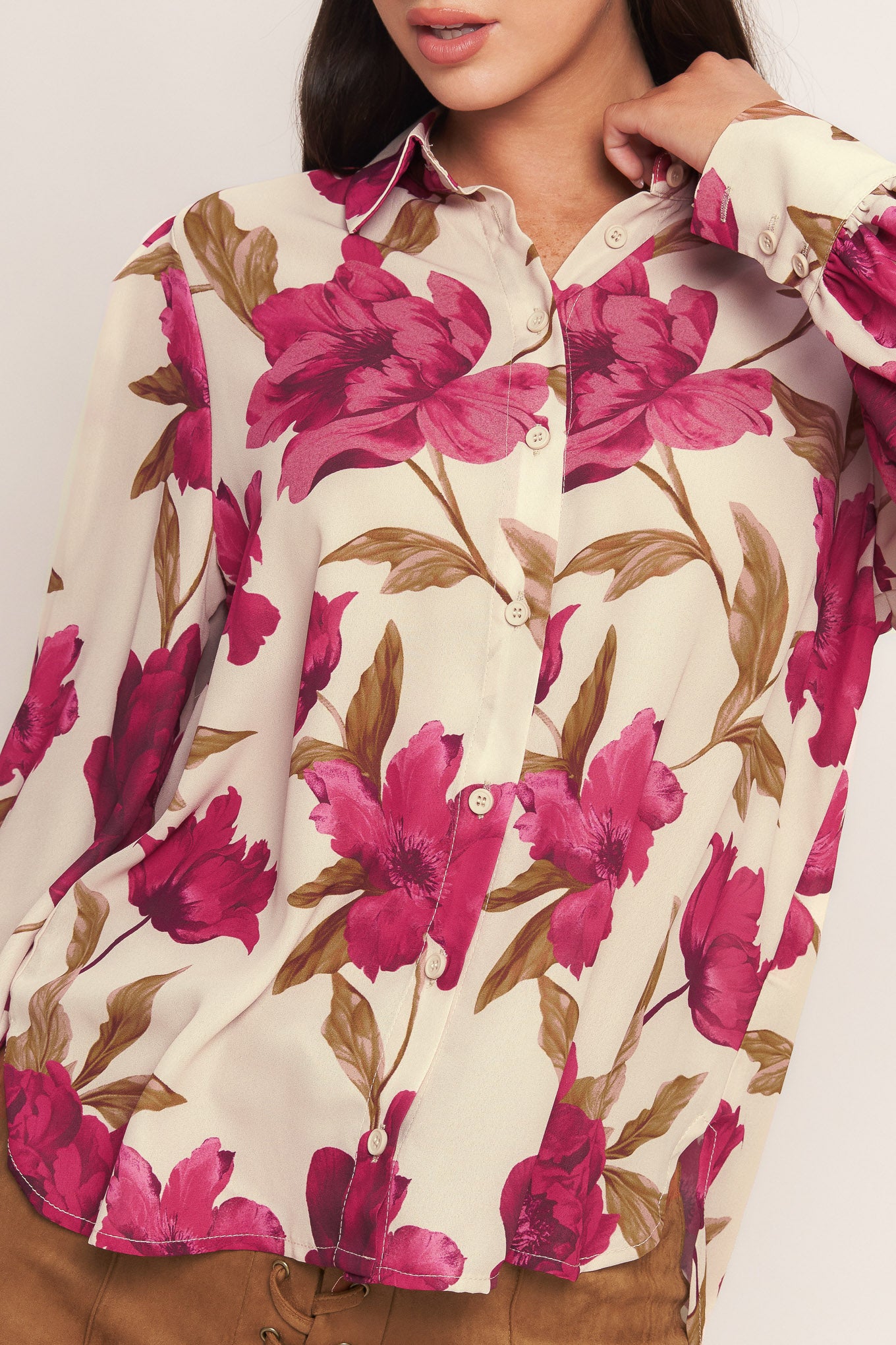 A printed woven top with front button down and long sleeve