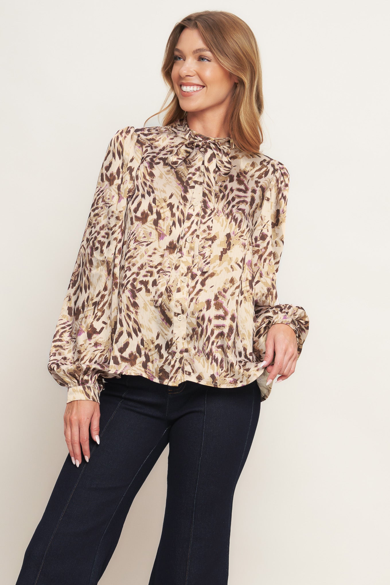 A printed woven top featuring round neckline with skinny tie, button down and long blouson sleeve