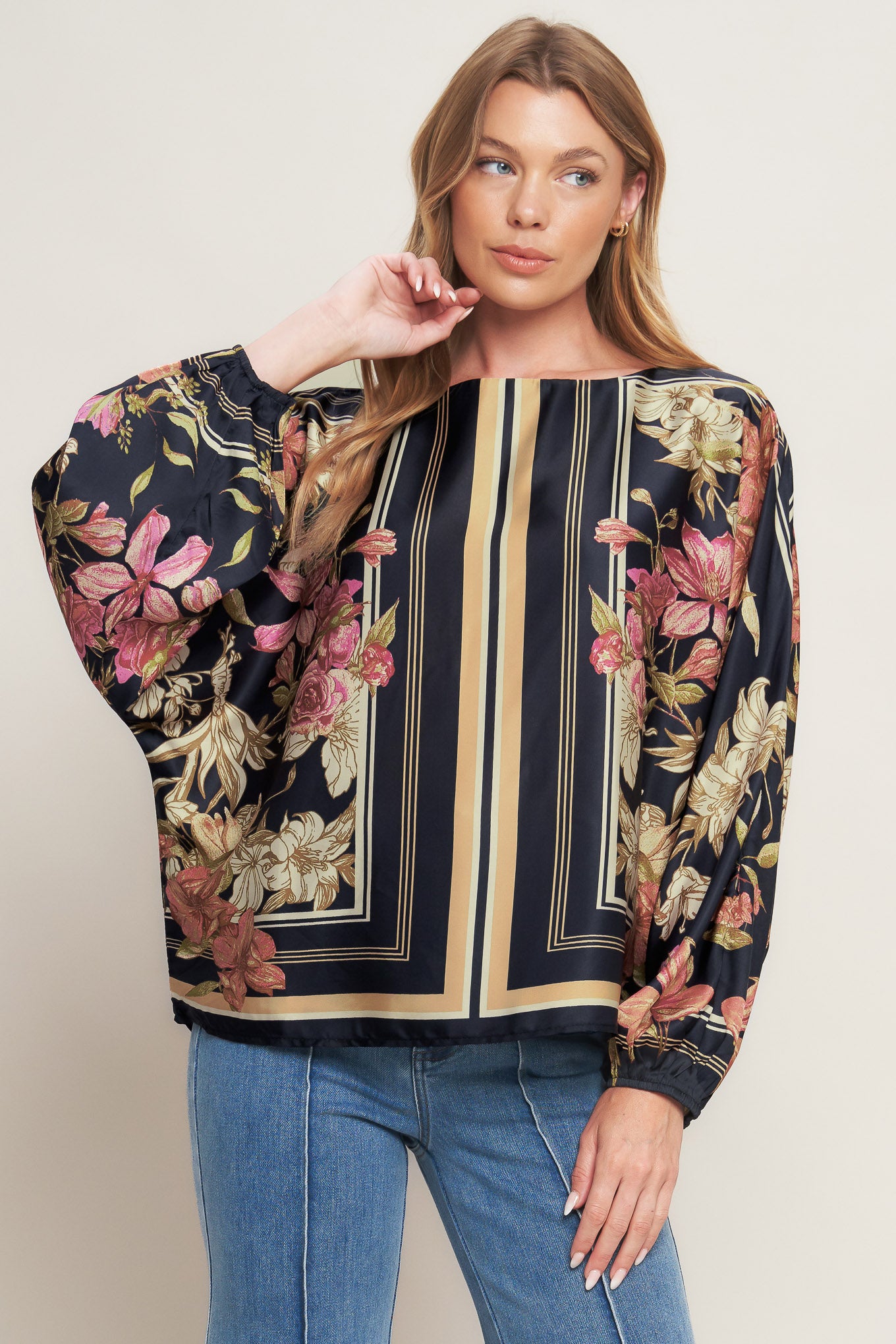 A printed woven top with wide neckline and long sleeve
