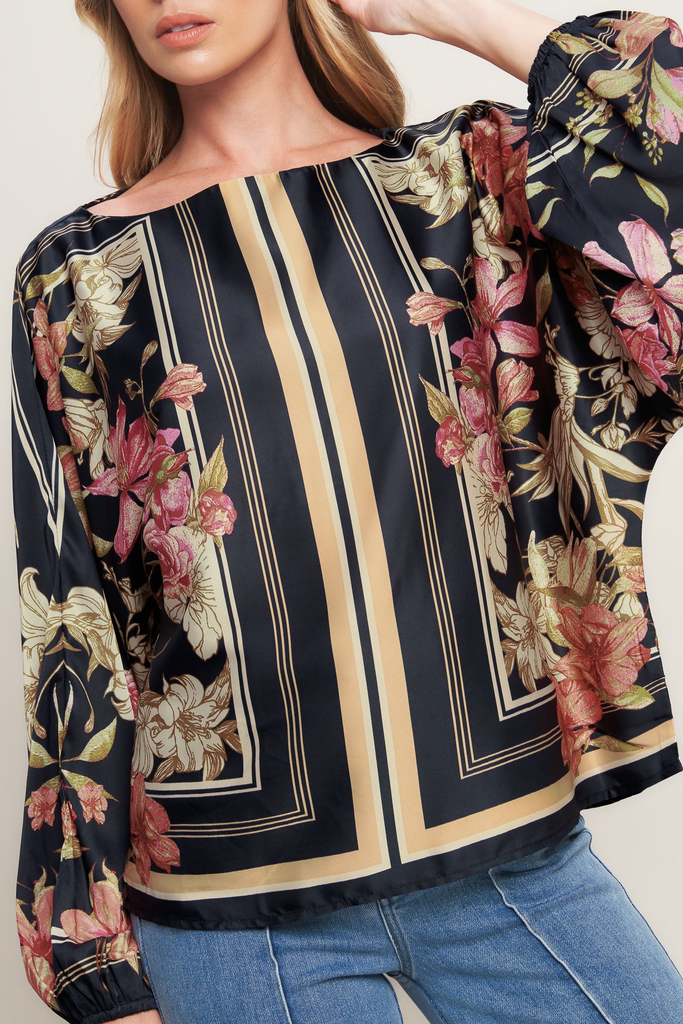 A printed woven top with wide neckline and long sleeve