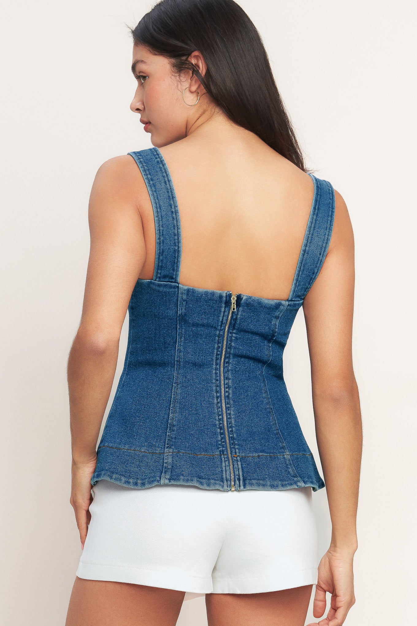 A washed denim top featuring straight neckline, shoulder strap, novelty button detail and back zipper closure
Details:
Self : 55% Cotton 33% Polyester 10% Viscose 2% Spandex
Size & Fit
- Model is 5`8" And Wearing Size Small
- Measurements Taken From Size Small
- Approx. Length: 23" Flying Tomato