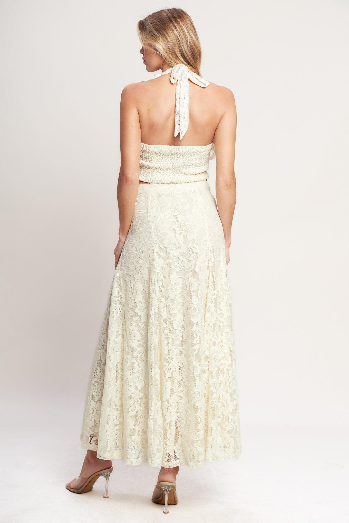 A woven lace top featuring halter neckline, ruffles, tie back and smocked back bodice. Matching skirt IK7780T
Details:
Self : 90% Nylon 10% Spandex
Lining : 100% Polyester
Size & Fit
- Model is 5`8" And Wearing Size Small
- Measurements Taken From Size Small
- Approx. Length: 18"