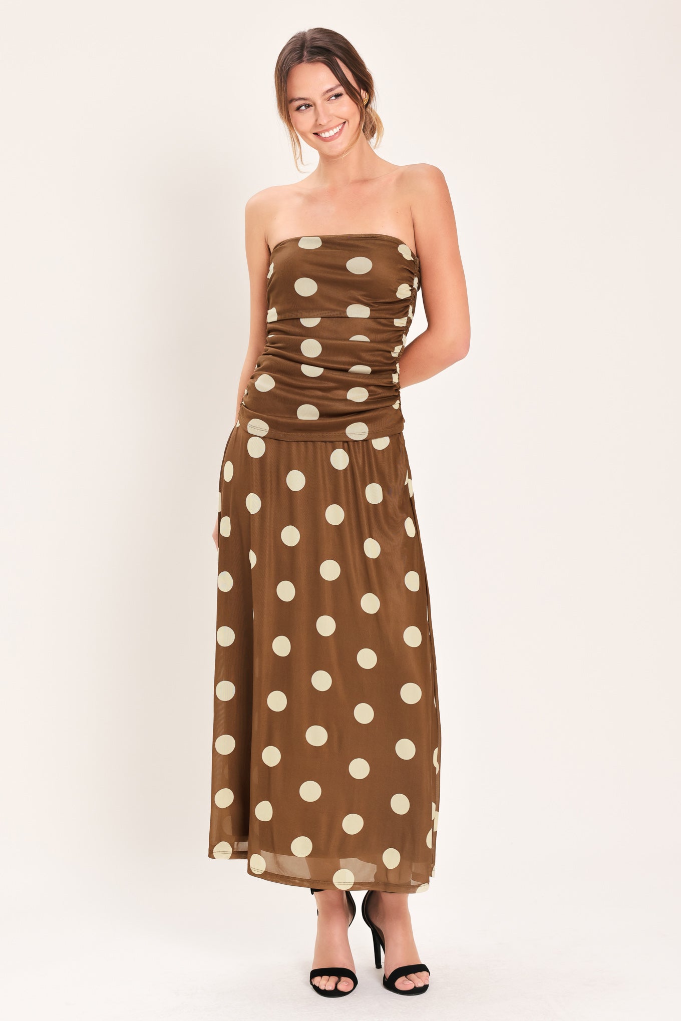 Woman wearing a brown strapless power mesh top with white polka dots and side shirring | Flying Tomato