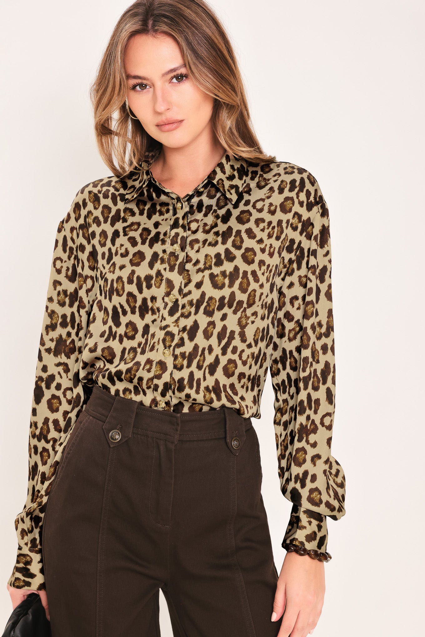 Woman wearing a long sleeve leopard print button down blouse top with collar | Flying Tomato