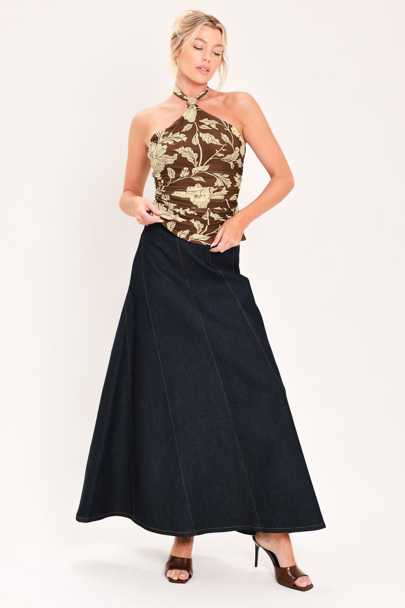 A woman wearing a brown halter-neck top with a beige floral print | Flying Tomato
