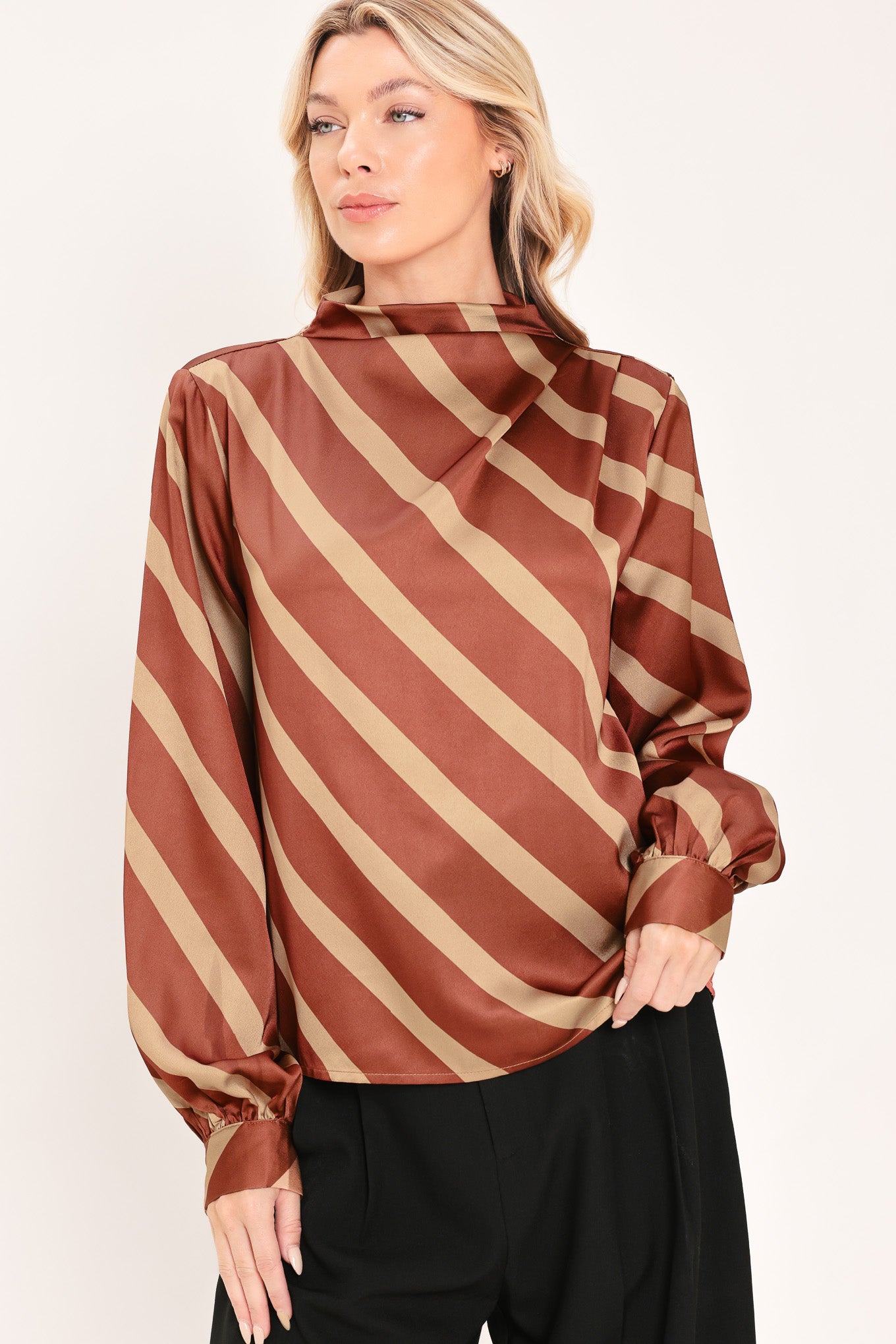 A woman wearing a brown and beige diagonally striped satin blouse with long balloon sleeves | Flying Tomato