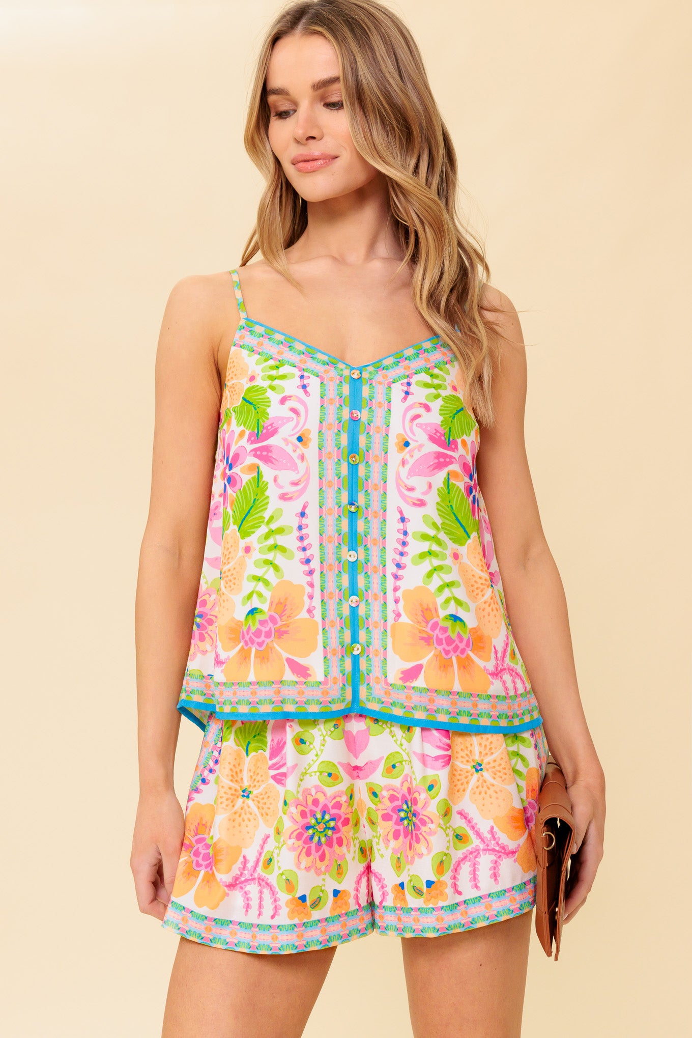 A printed woven top and short set. Cami top featuring straps and button down detail. Short featuring pleated front and elasticized back waist band