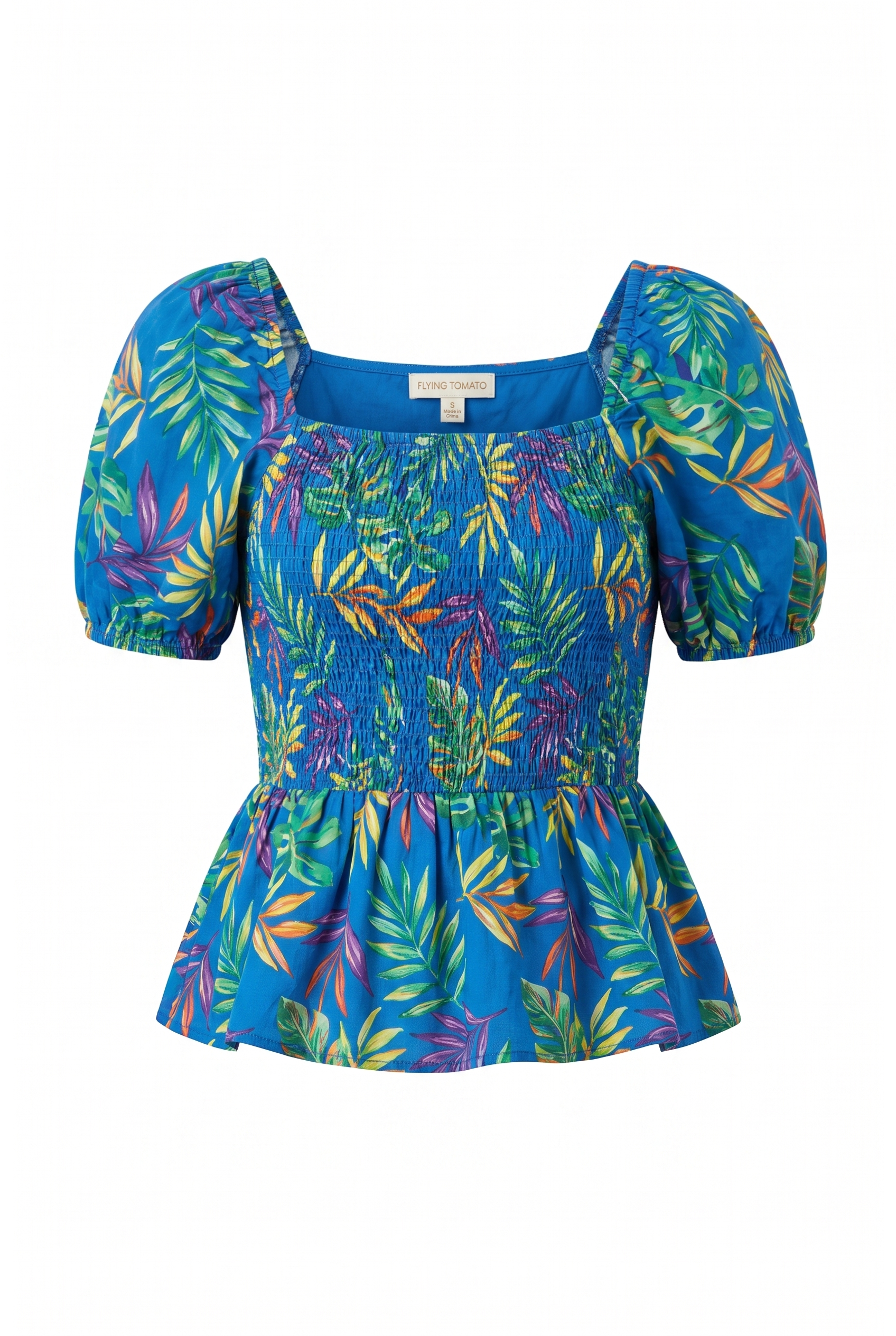 A vibrant blue puff-sleeve top with a colorful tropical leaf print, featuring a smocked bodice and a flared peplum hem, shown against a plain white background.