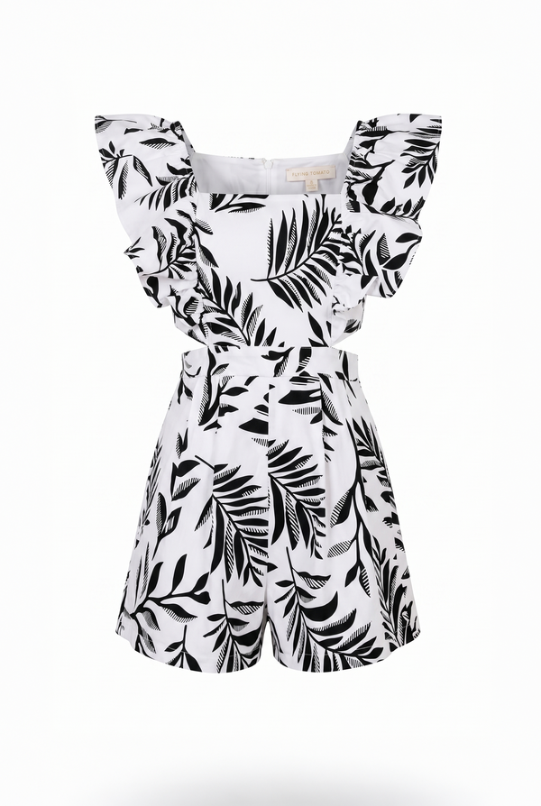 White romper with black leaf pattern on a white background