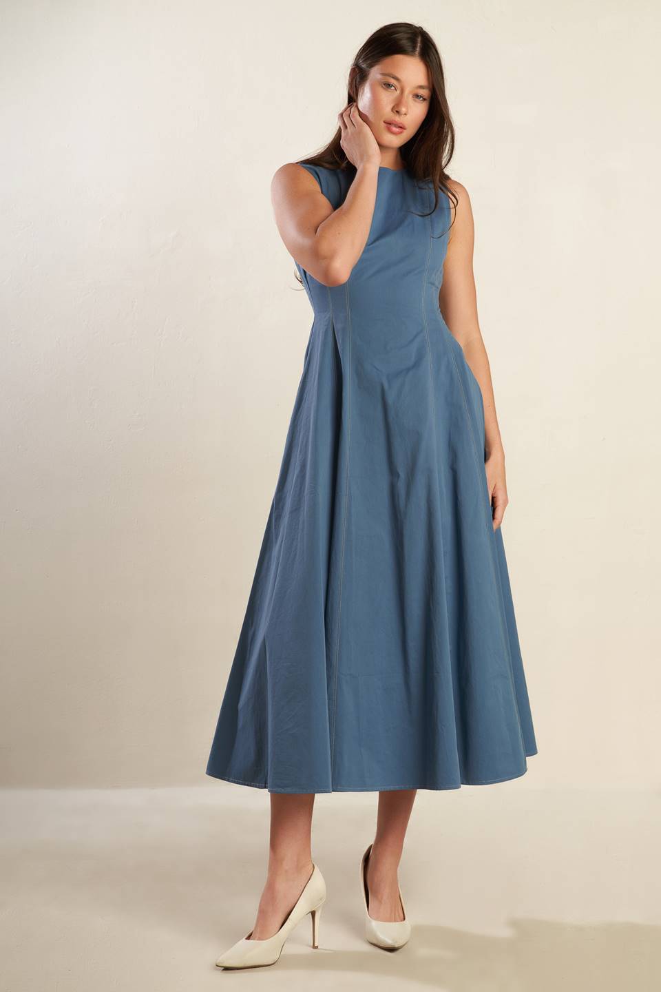 A solid woven midi dress featuring round neckline, sleeveless, full skirt and back zipper closure.