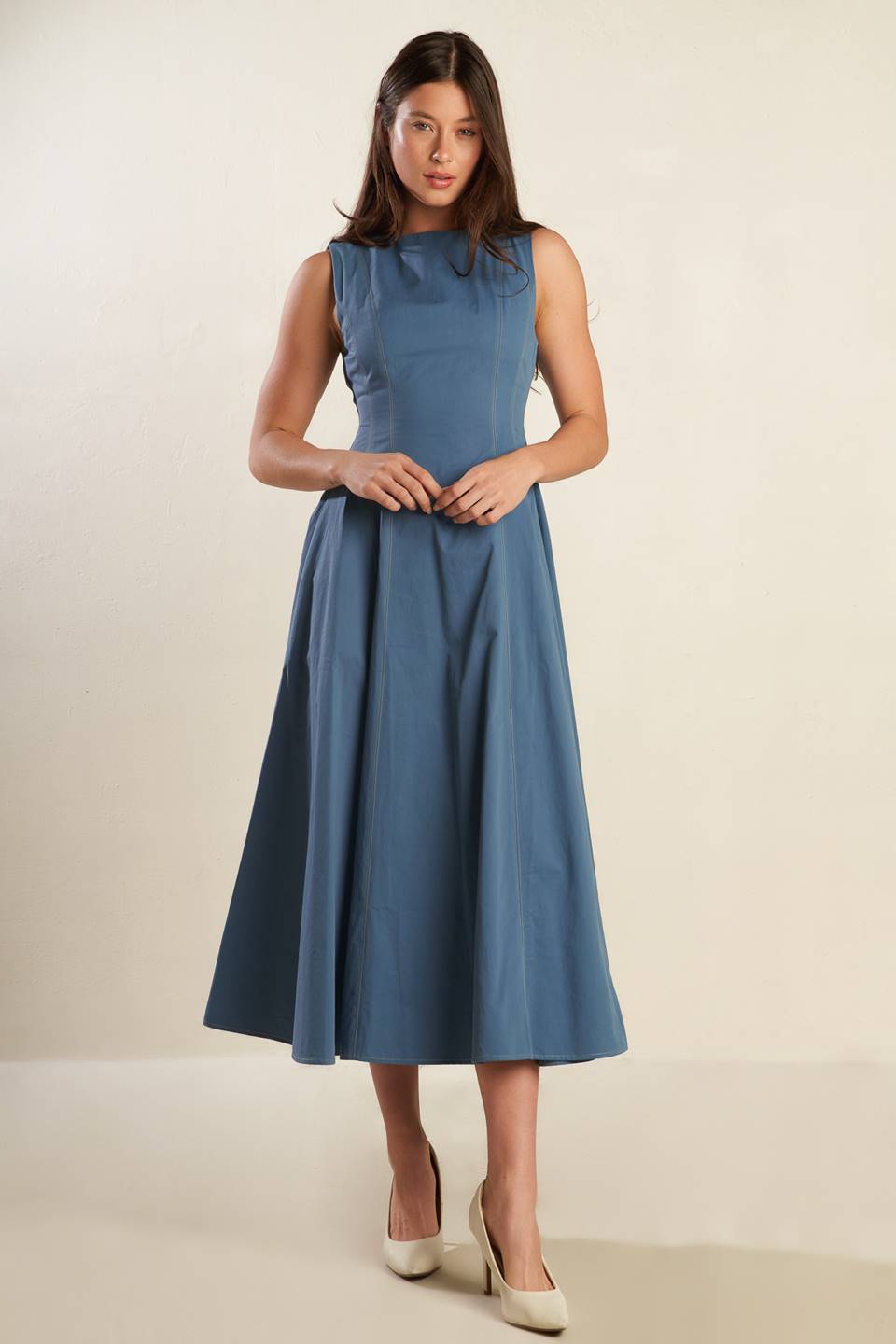 A solid woven midi dress featuring round neckline, sleeveless, full skirt and back zipper closure.