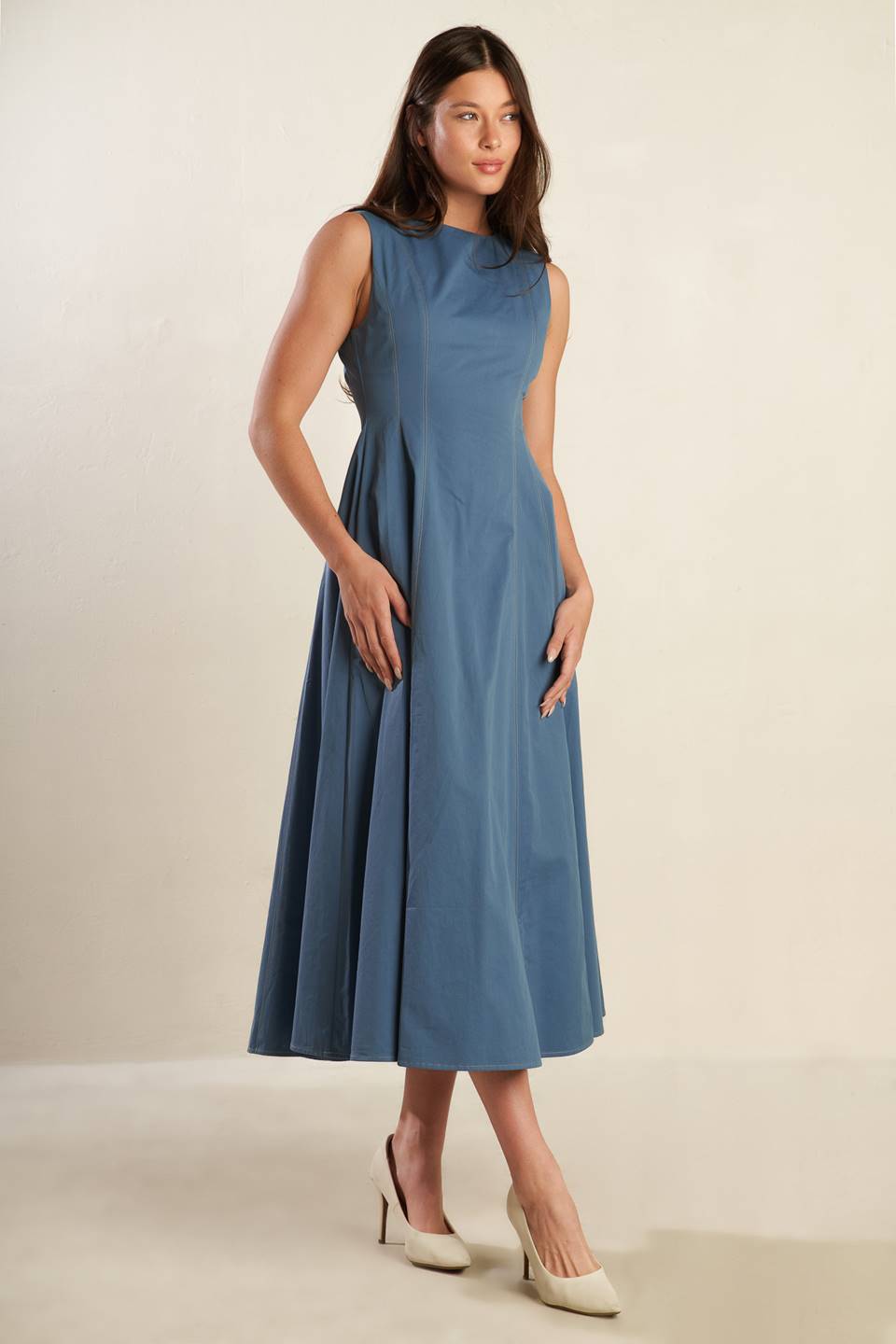 A solid woven midi dress featuring round neckline, sleeveless, full skirt and back zipper closure.