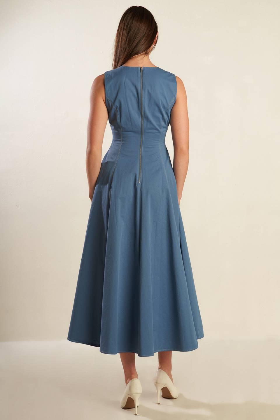 A solid woven midi dress featuring round neckline, sleeveless, full skirt and back zipper closure.