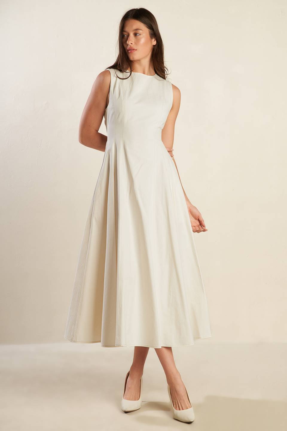 A solid woven midi dress featuring round neckline, sleeveless, full skirt and back zipper closure.