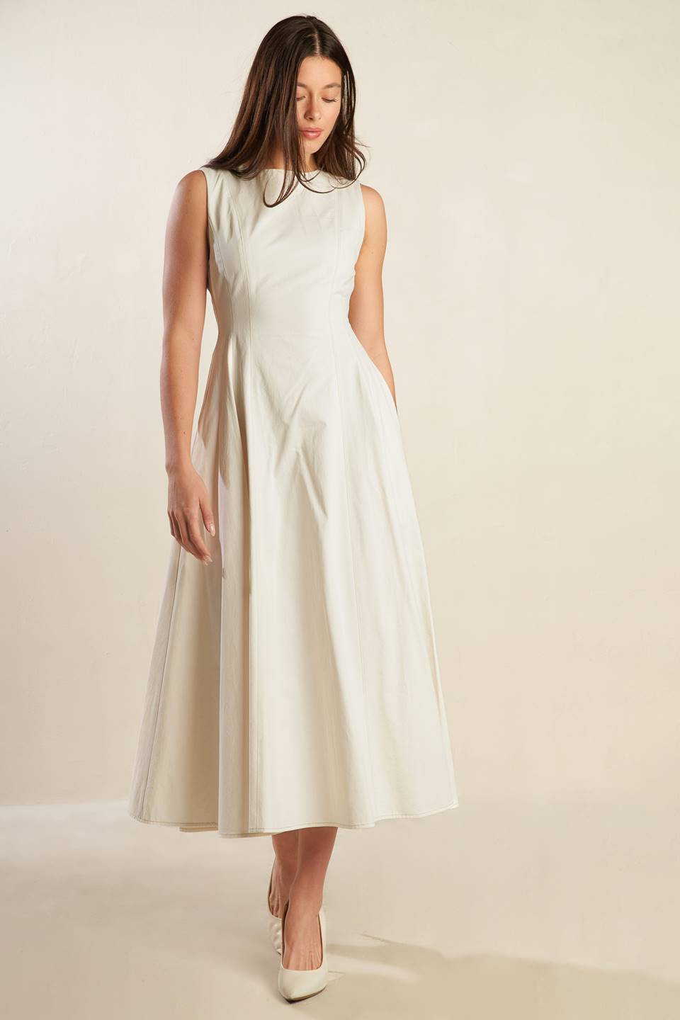 A solid woven midi dress featuring round neckline, sleeveless, full skirt and back zipper closure.