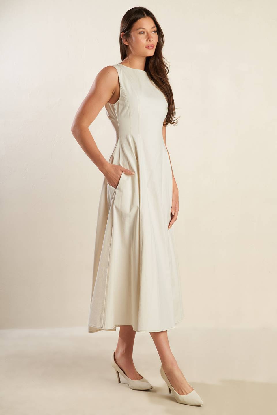 A solid woven midi dress featuring round neckline, sleeveless, full skirt and back zipper closure.