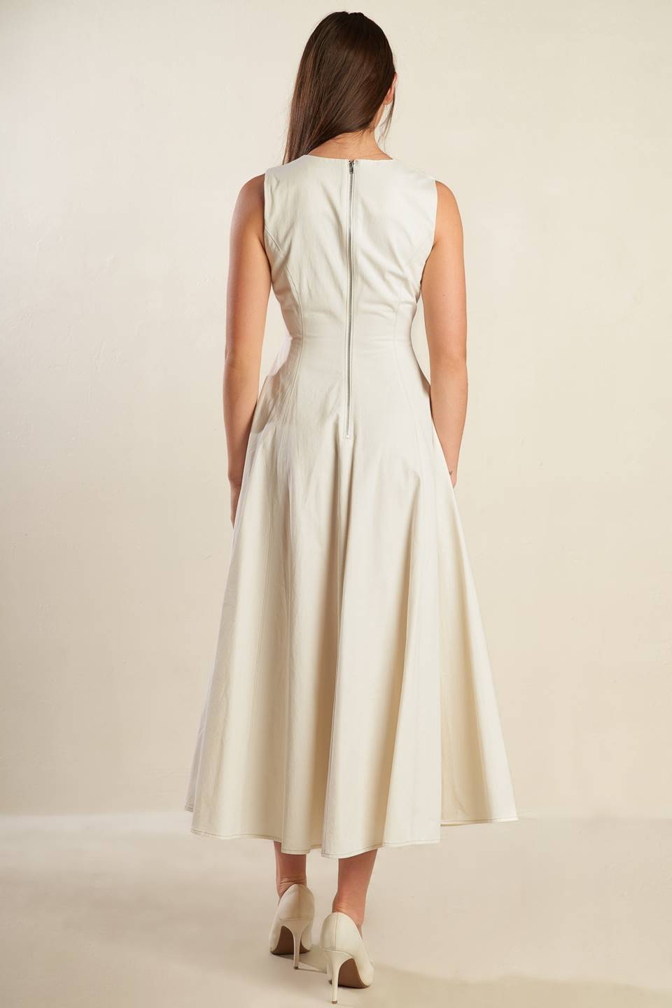 A solid woven midi dress featuring round neckline, sleeveless, full skirt and back zipper closure.