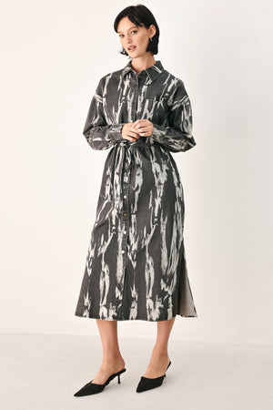 A woman modeling a long-sleeve button-front shirt denim midi dress with a gray and white abstract print | FREEMARKET
