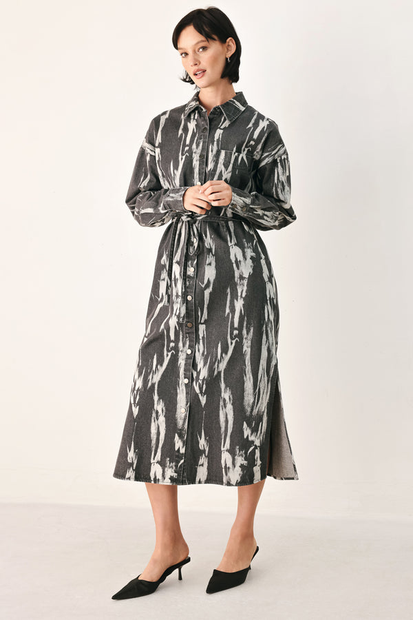A woman modeling a long-sleeve button-front shirt denim midi dress with a gray and white abstract print | FREEMARKET