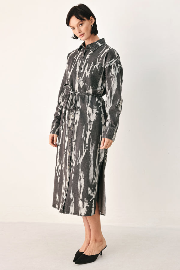 A woman modeling a long-sleeve button-front shirt denim midi dress with a gray and white abstract print | FREEMARKET