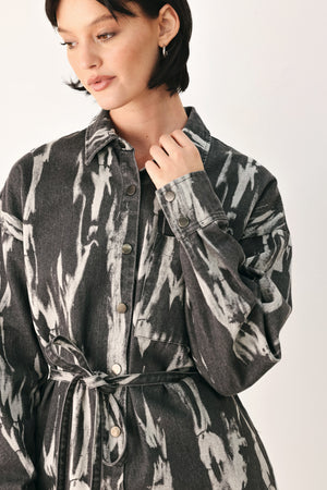 A woman modeling a long-sleeve button-front shirt denim midi dress with a gray and white abstract print | FREEMARKET