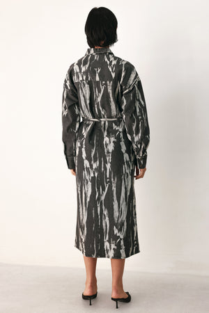 A woman modeling a long-sleeve button-front shirt denim midi dress with a gray and white abstract print | FREEMARKET