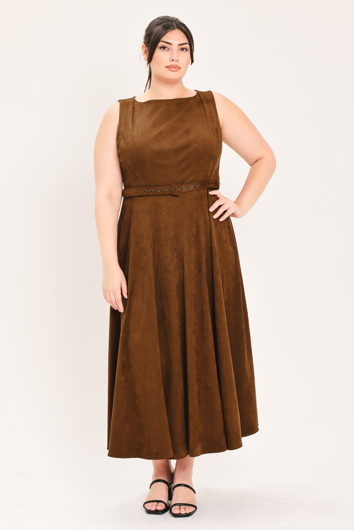 A woman wearing a sleeveless tobacco brown midi dress with a structured bodice, matching belt, and full skirt | FREEMARKET Curve