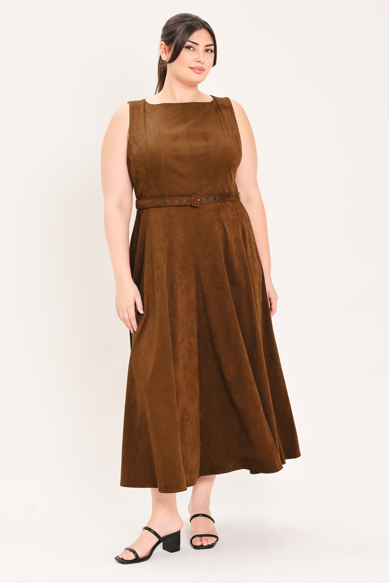 A woman wearing a sleeveless tobacco brown midi dress with a structured bodice, matching belt, and full skirt | FREEMARKET Curve