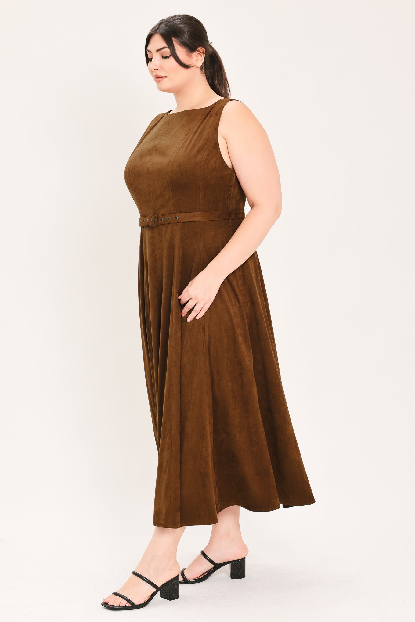 A woman wearing a sleeveless tobacco brown midi dress with a structured bodice, matching belt, and full skirt | FREEMARKET Curve