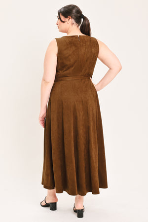 A woman wearing a sleeveless tobacco brown midi dress with a structured bodice, matching belt, and full skirt | FREEMARKET Curve