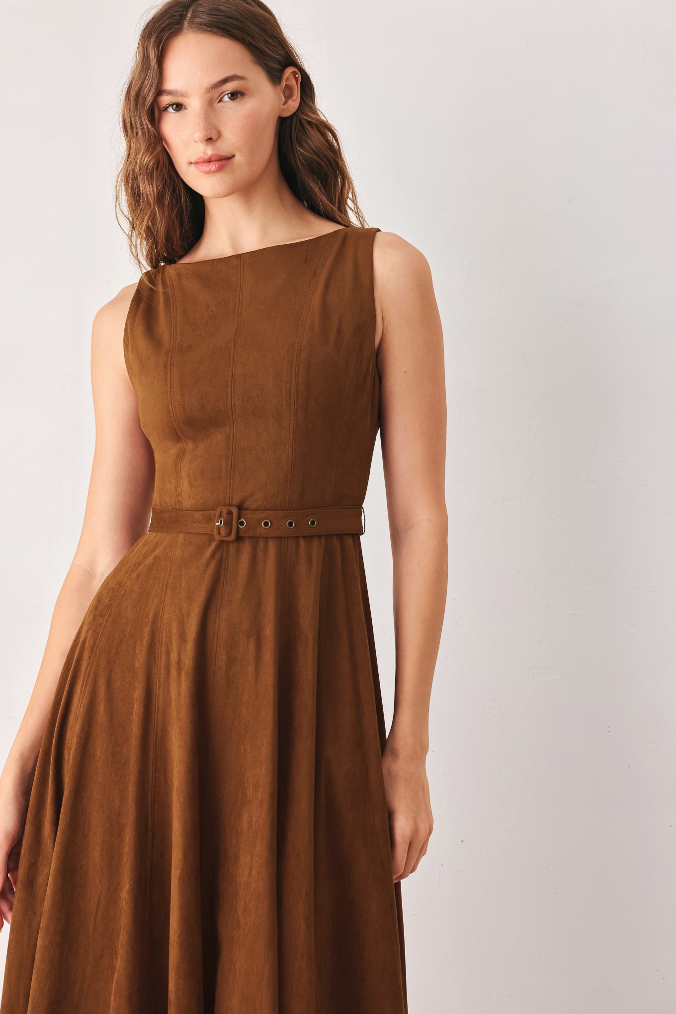 A woman wearing a sleeveless tobacco brown midi dress with a structured bodice, matching belt, and full skirt | FREEMARKET