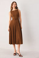 A woman wearing a sleeveless tobacco brown midi dress with a structured bodice, matching belt, and full skirt | FREEMARKET