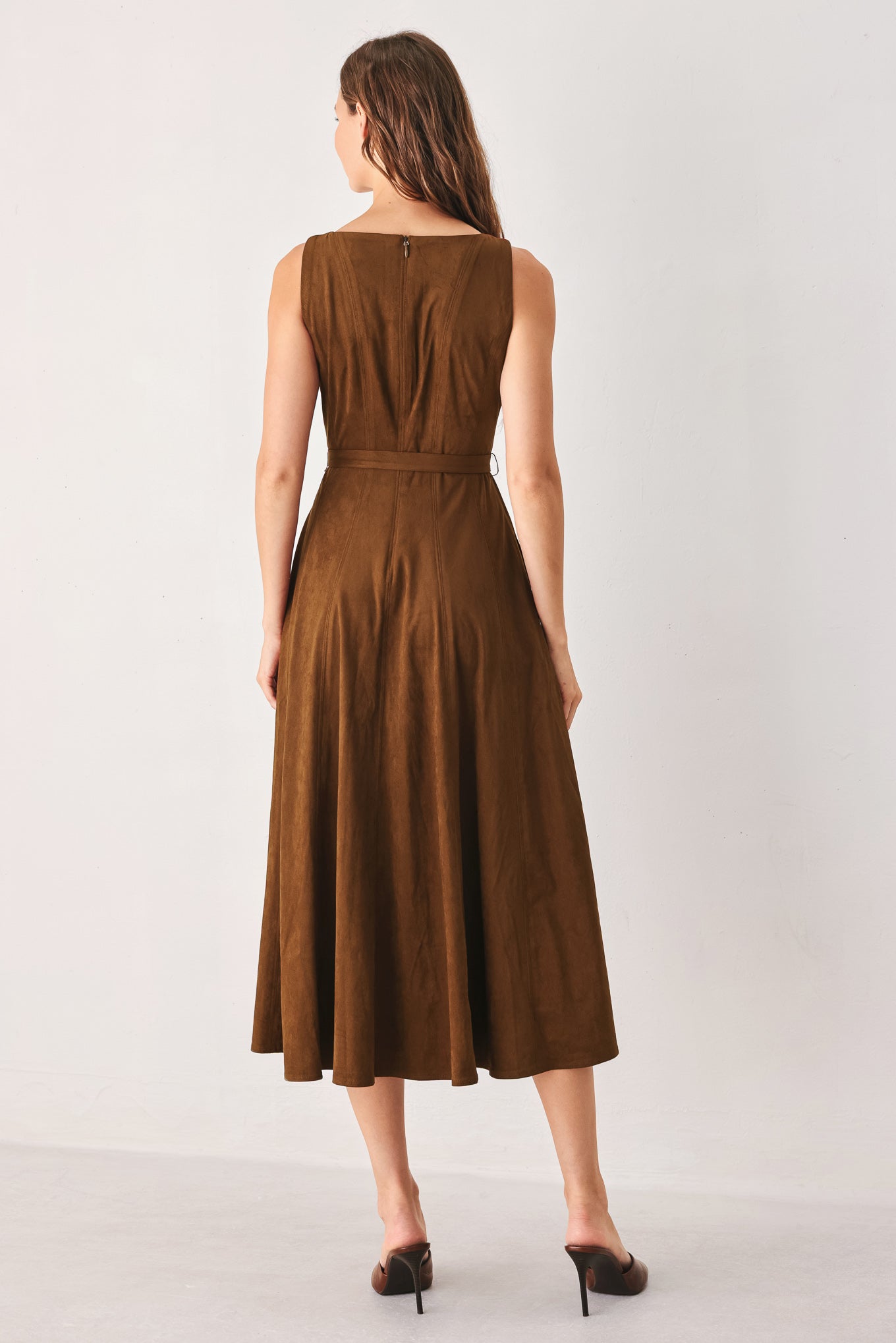 A woman wearing a sleeveless tobacco brown midi dress with a structured bodice, matching belt, and full skirt | FREEMARKET