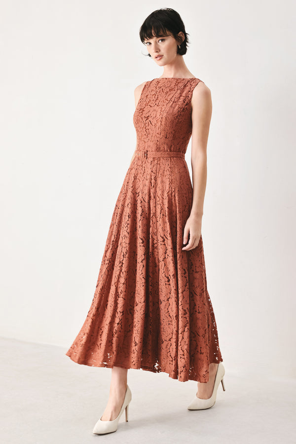Woman wearing a rust colored lace midi dress featuring wide neckline, sleeveless, self belt, full circle skirt and back zipper closure | FREEMARKET