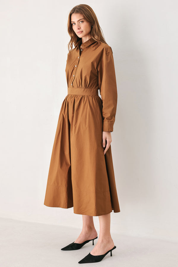 A woman modeling a rust long-sleeve midi shirt dress with a button-up front and gathered waist | FREEMARKET