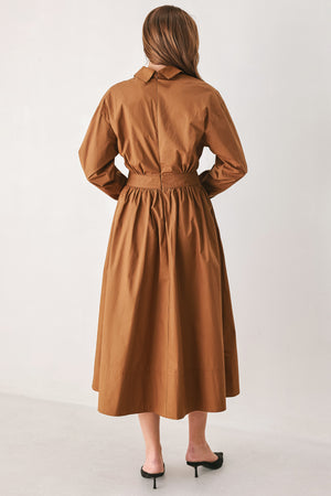A woman modeling a rust long-sleeve midi shirt dress with a button-up front and gathered waist | FREEMARKET