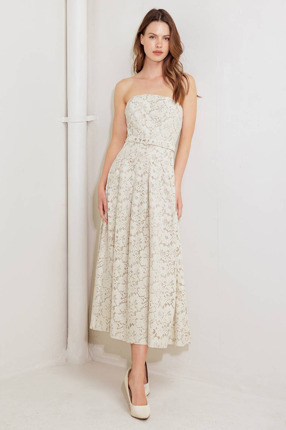 A strapless, woven lace midi dress featuring straight neckline, self belt, full skirt and back zipper closure