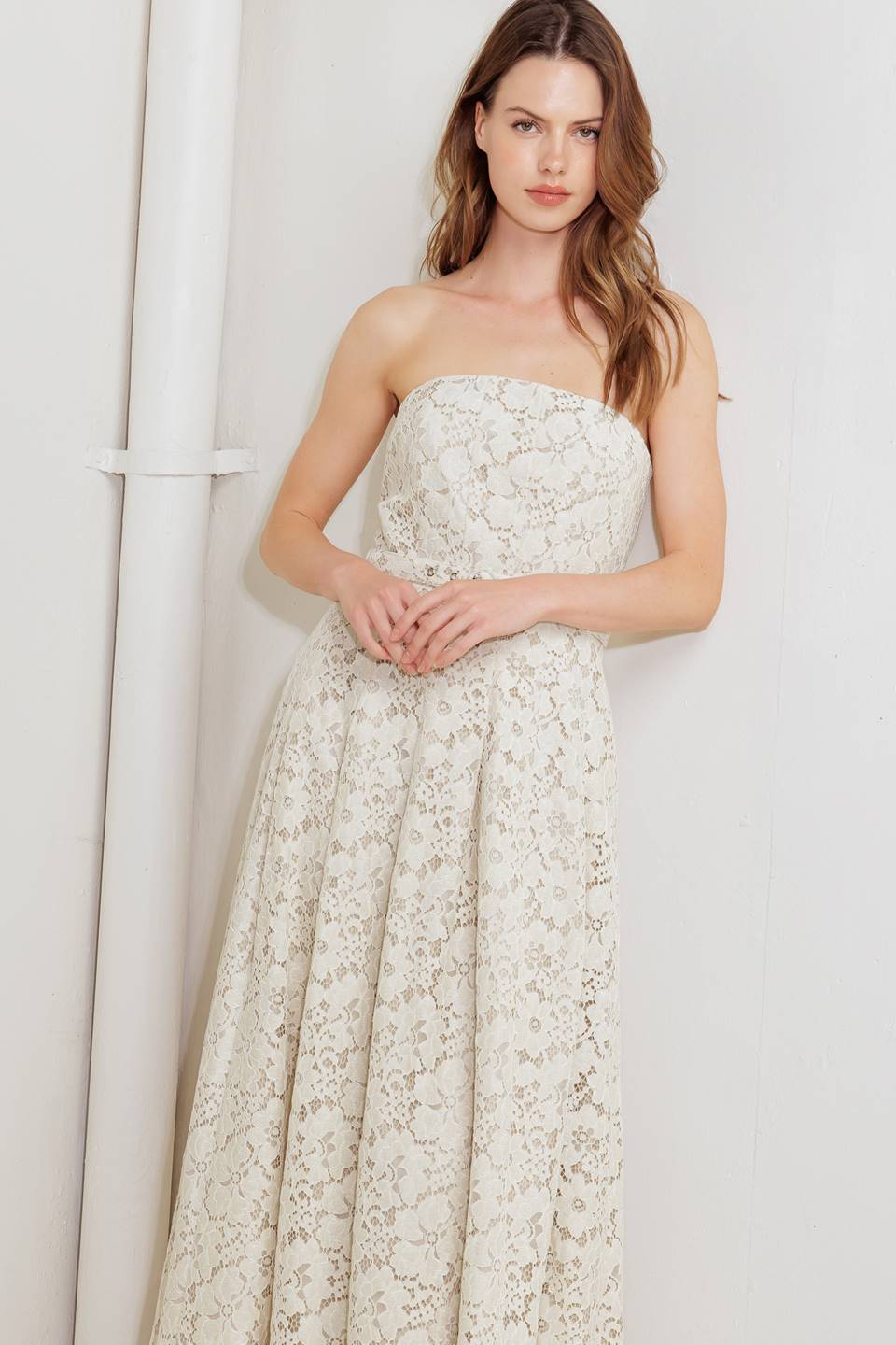 A strapless, woven lace midi dress featuring straight neckline, self belt, full skirt and back zipper closure