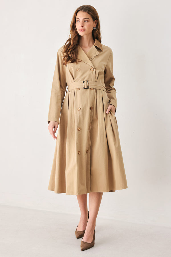 A woman models a beige double-breasted trench coat with a matching waist belt, paired with brown pointed-toe heels | FREEMARKET