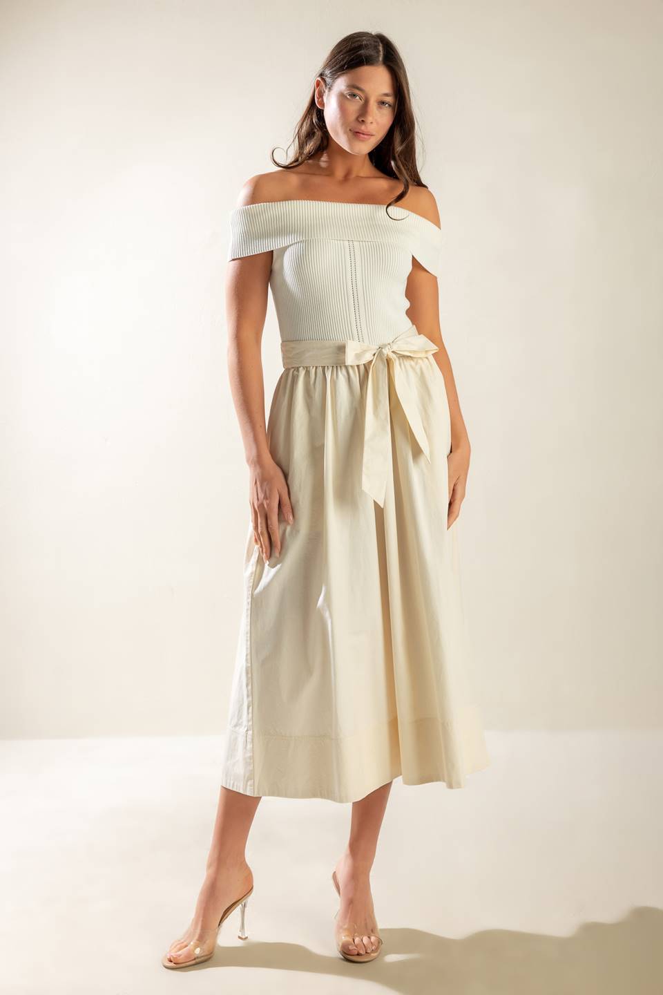 A sweater off shoulder top with full woven skirt and self sash belt.